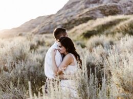 man hugging woman near mountain
