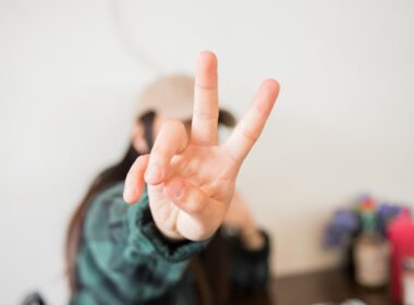 person doing peace sign