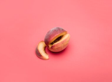 sliced apple fruit on pink surface